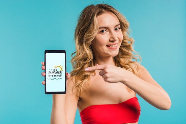 Attractive woman presenting smartphone mockup