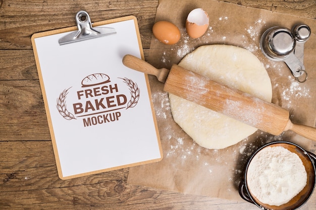 Bakery recipe on clipboard and dough