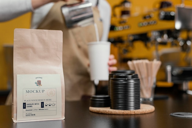 Barista working near coffee packaging mockup