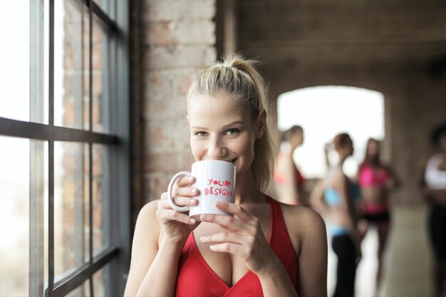 A Beautiful fit women with a mug Mockup