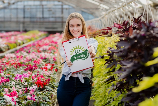 Beautiful young girl holding eco friendly sign