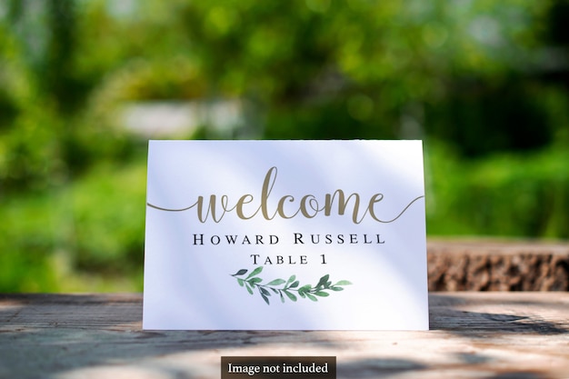 Bi-fold Table Card on greenery blurred outdoor Mock-up