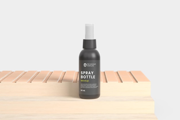 A black spray bottle sits on a wooden crate.