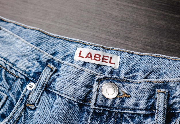 Blank clothing label on denim jeans texture Label with empty space for text