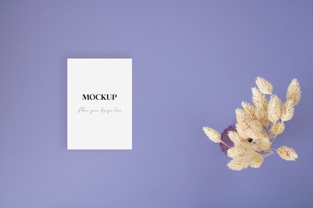 Blank greeting card mock up with dry grass on the blue background