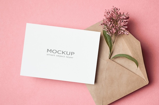 Blank invitation card mockup with envelope and flowers