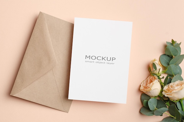 Blank invitation or engagement card mockup with envelope and flowers