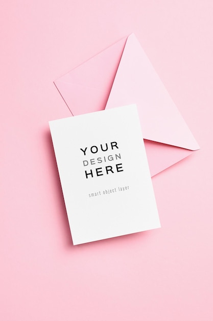 Blank invitation or greeting card mockup with envelope on pink