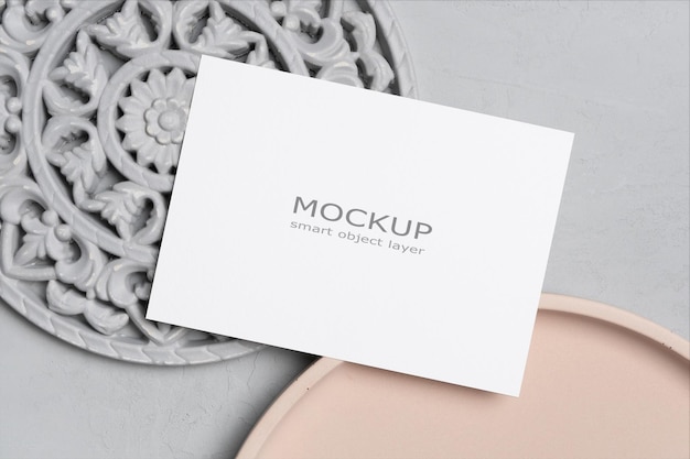 Blank wedding invitation card mockup on concrete background with decor