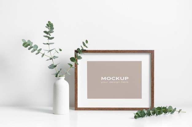 Blank wooden art frame mockup in white minimalistic room interior