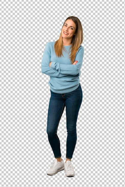 Blonde woman with blue shirt keeping the arms crossed in frontal position