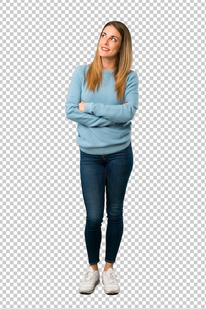 Blonde woman with blue shirt looking up while smiling