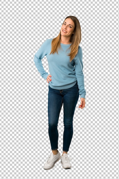 Blonde woman with blue shirt posing with arms at hip and smiling