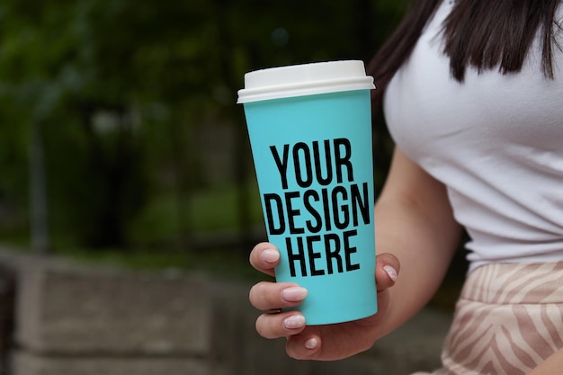 Blue coffee mug mockup in the hands of a girl changeable color psd