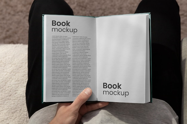 Book mock-up hand held by person