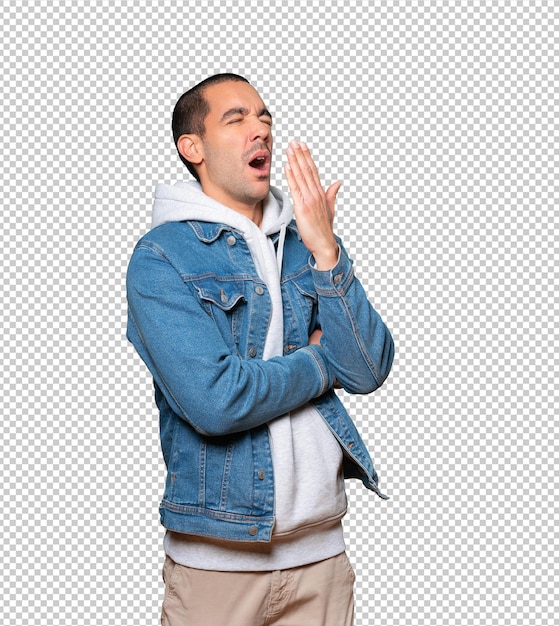 Bored young man doing yawning gesture