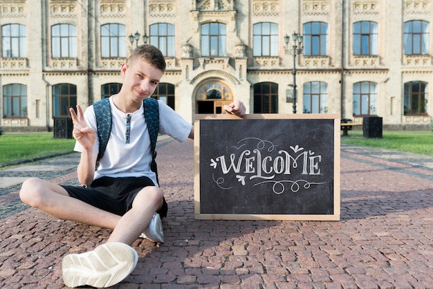 Boy holding a blackboard mock-up