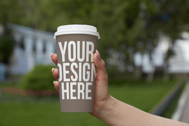 Brown colored paper coffee cup on the table mockup custom design changeable color closeup