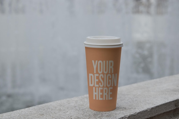 Brown colored paper coffee cup on the table mockup custom design changeable color closeup