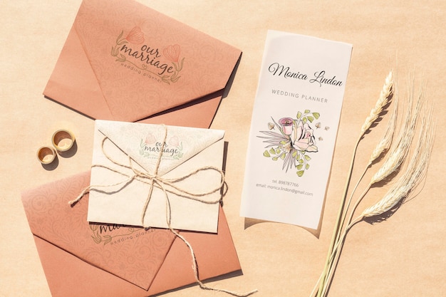 Brown paper envelopes with wedding invitations and rings