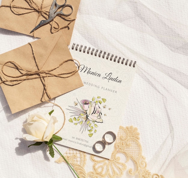 Brown paper envelopes with wedding rings and rose