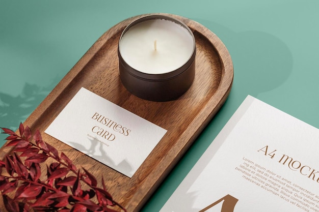 PSD business card mockup and a4 mockup on wooden plate with candle