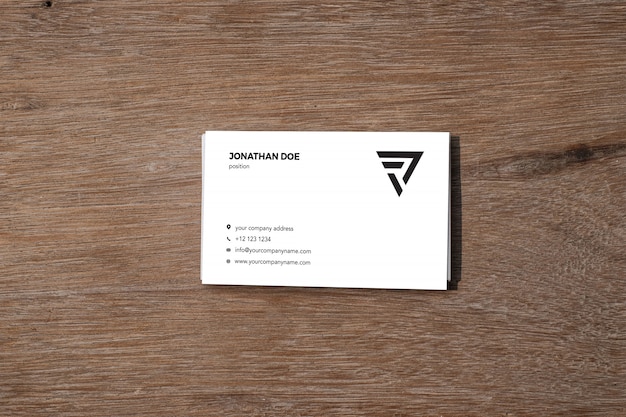 Business card mockup on wooden table