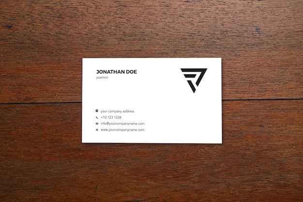 Business card mockup on wooden table