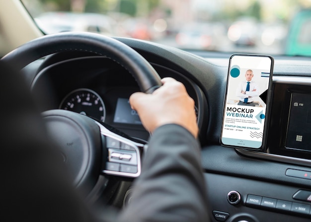 Business man in car with phone mockup