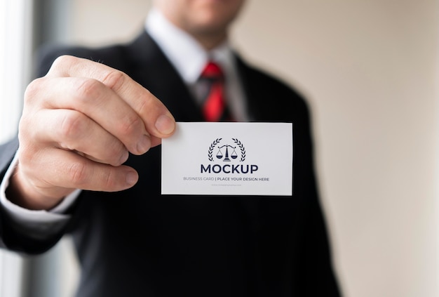 Businessman holding business card mock-up with one hand