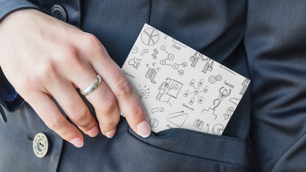 Businessman pulling notebook out of pocket