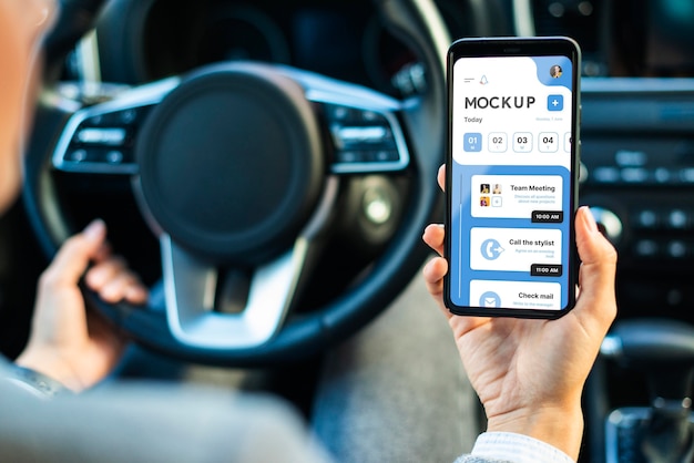 Businesswoman in car holding phone mockup