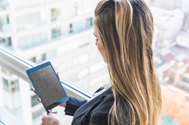 Businesswoman with tablet in front of city skyline