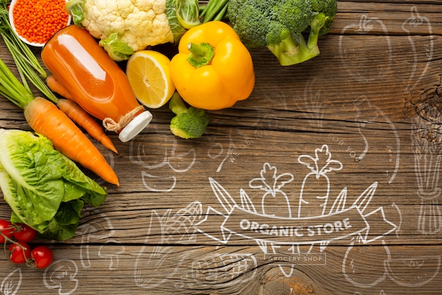 Carrot juice and vegetables on wooden table