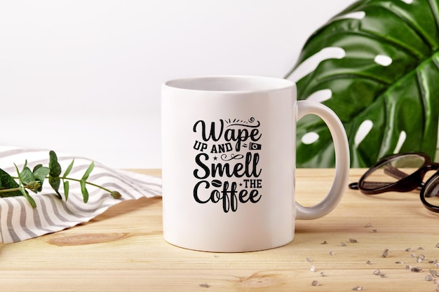 Ceramic mug on wooden desktop next to striped tablecloth scattered crystals and green plants on white background Close up copy space