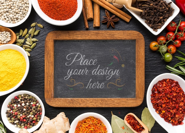 Chalkboard with wooden frame mock-up surrounded by spices and herbs