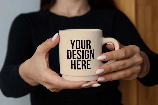 Changeable color a girl holding a coffee mug in her hands closeup mockup psd