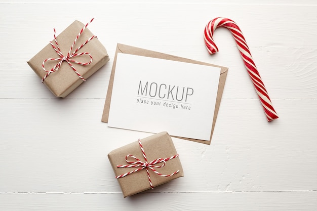 Christmas card mockup with gift boxes and candy cane