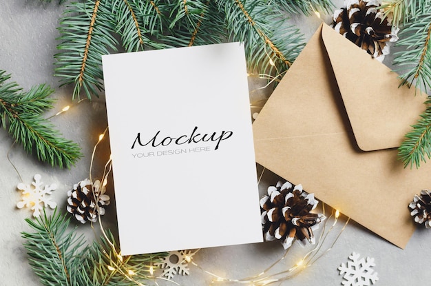 Christmas greeting card mockup with envelope and lighting garlands