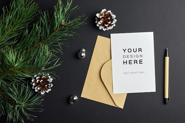 Christmas greeting card mockup with pine tree branches and cones on dark