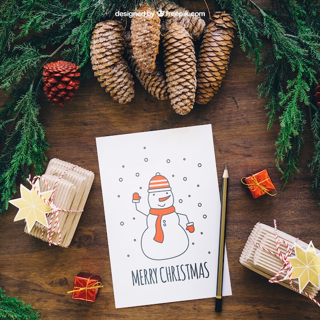 PSD christmas mockup with pine cones and card