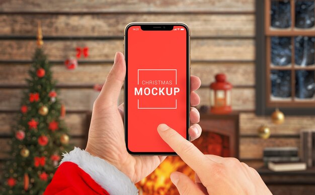 Christmas phone mockup in Santa Claus hands