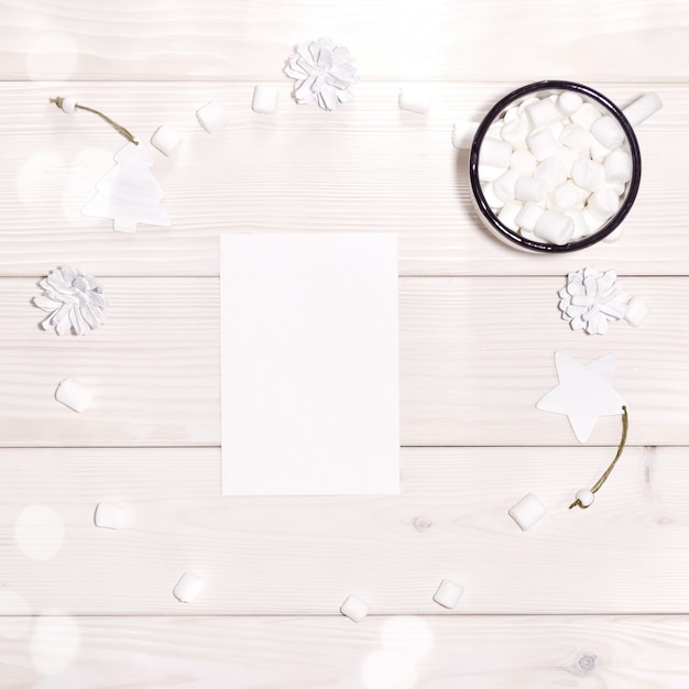 Christmas with card mockup and white decorations on  wood table