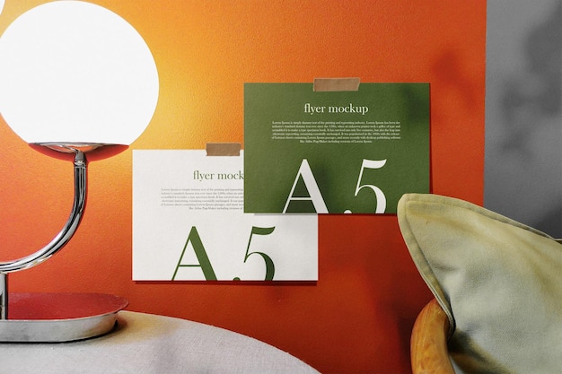 Clean minimal A5 flyer mockup on the wall with lamp and chair background