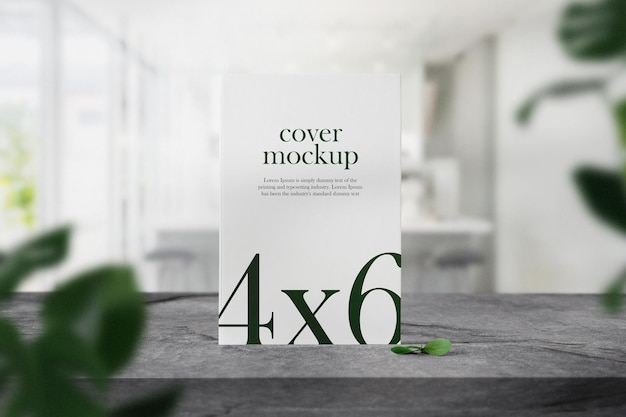 Clean minimal book 4x6 mockup on top table in cafe with leaves