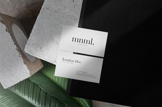 Clean minimal business card mockup on black book 