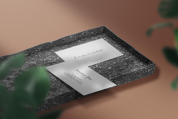 Clean minimal business card mockup on black stone plate