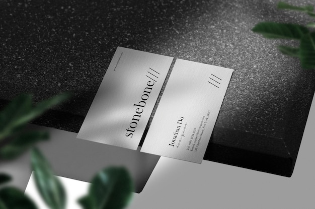 Clean minimal business card mockup on black stone table