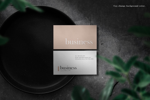 Clean minimal business card mockup on plate with leaves shadow background.  