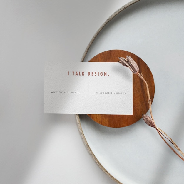 Clean minimal business card mockup wooden plate with dried flower background PSD file